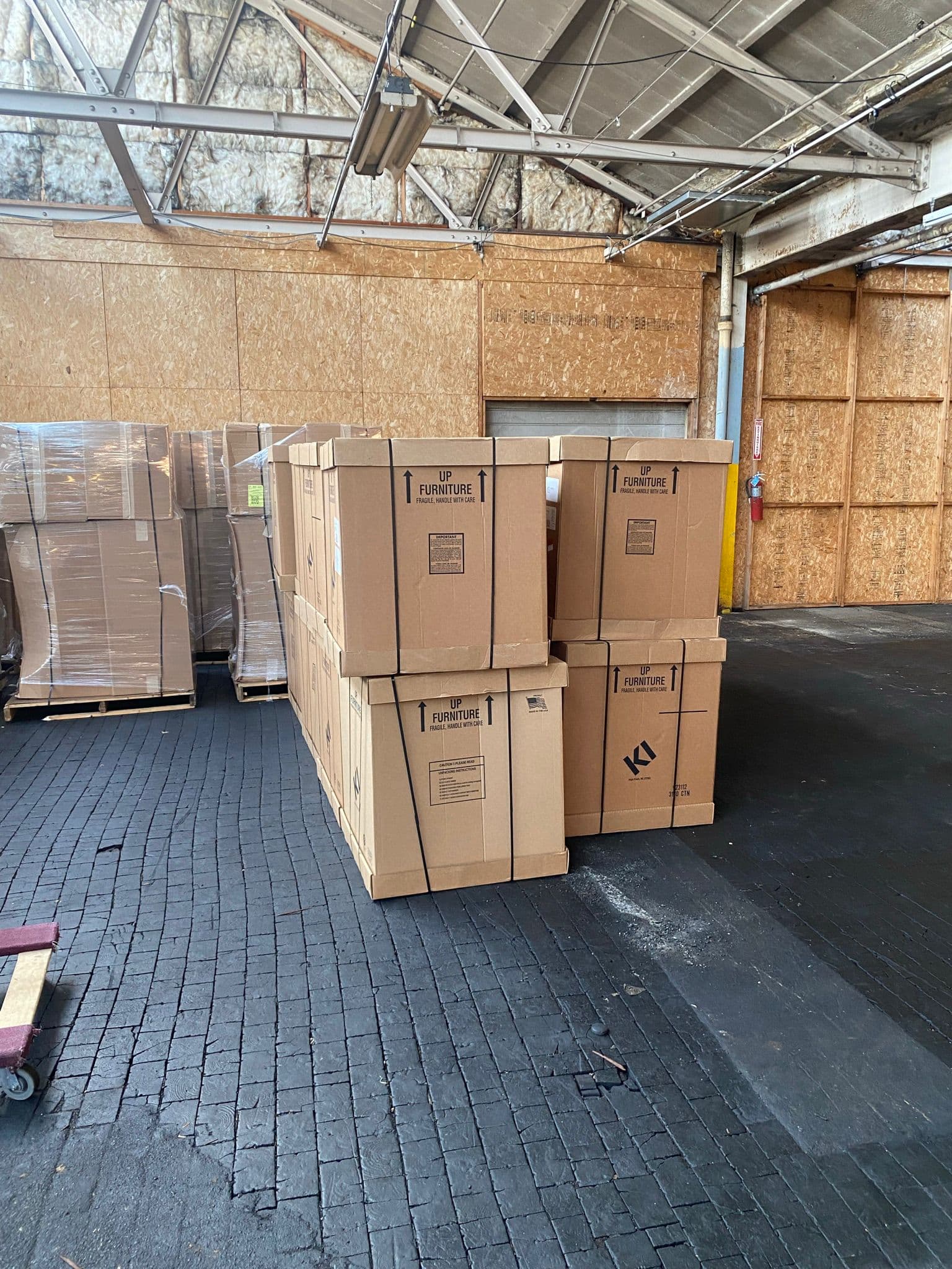 Palletized and crated goods inside the Kiper warehouse